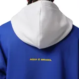 Canguro Nike Jordan de algodón, color azul con capucha blanca. Presenta el logo Jumpman en color amarillo integrado en la palabra 'BRASIL' estampada en el frente. Cuenta con bolsillo tipo canguro y puños acanalados.