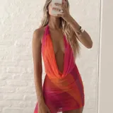 Vestido corto de microtul con estampado degradado en tonos rosado y naranja, diseño con escote profundo tipo halter y ajuste entallado.