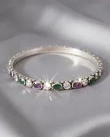 Pulsera esclava de plata 925 con diseño articulado, engastada con piedras naturales en tonos verde, violeta y circonias blancas brillantes.