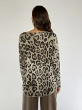 Sweater gris oscuro con estampado animal print en negro, escote en V y mangas largas.