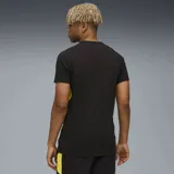 Remera deportiva Puma del Club Atlético Peñarol, color negro con detalles en amarillo en los laterales y mangas. Presenta el logo de la marca y el escudo del club en el frente.