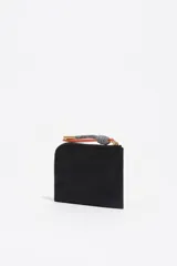 Monedero compacto de Bimba y Lola en color bordó, con cierre de cremallera superior y logo metálico dorado en el frente.