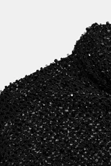 Camisa de hilatura con viscosa color negro, con cuello subido y manga larga ancha. Presenta aplicaciones de abalorios combinados a tono en toda la prenda y bajo recto.