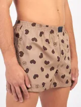 Bóxer de algodón blanco con estampado de flores pequeñas color celeste, con cintura elástica y logo de la marca en el centro.