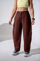 Pantalón sastrero de corte holgado y tiro alto, color marrón chocolate, con cintura elástica y lazo ajustable del mismo tono.