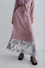 Falda midi color rosa con aplique de lentejuelas plateadas en el ruedo.