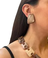 Aros cortos de resina color marrón claro con acabado brillante.