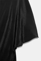 Vestido largo negro de la colección ZW de Zara, confeccionado en tejido satinado. Cuenta con un diseño asimétrico que incorpora una capa superpuesta y un corte fluido.