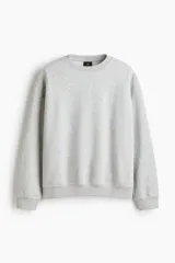 Buzo de cuello redondo color gris melange, de corte holgado, con hombros caídos y puños y dobladillo acanalados.