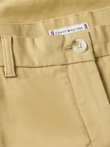 Shorts de mujer estilo chino, color beige claro, con cierre de botón y cremallera, y bolsillos laterales y traseros.