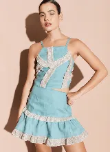 Minifalda negra de lino con volados y detalles de brillos en los bordes.