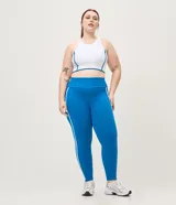 Pantalón legging deportivo Get Over de color azul, confeccionado en microfibra con cintura alta y ancha, recortes anatómicos y bies contrastante blanco a los lados.