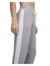 Conjunto deportivo Under Armour de tricot gris, compuesto por una campera con cierre frontal y cuello alto, y un pantalón de jogging con cordón ajustable en la cintura y franjas blancas laterales.