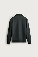 Sudadera polo de corte regular, confeccionada en tejido técnico interlock de algodón con elasticidad. Presenta cuello solapa, cierre frontal de cremallera y manga larga con puños acabados en rib.