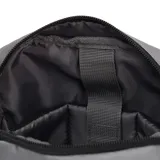 Bolso cruzado Caterpillar modelo Shoulder Bag, color gris medio, con correa ajustable negra y compartimento principal con cierre vertical. Presenta el logo CAT en la parte inferior frontal y una etiqueta amarilla con el nombre CATERPILLAR en el lateral.