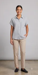 Camisa de manga corta color azul claro, confeccionada en tela de algodón con textura arrugada. Presenta cuello clásico, cierre frontal con botones y un bolsillo aplicado en el pecho.