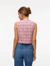 Chaleco sastrero de tejido plano con estampado tweed en tonos rosados, negros y blancos. Diseño sin mangas con corte regular.