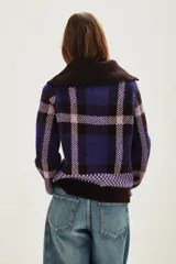 Cardigan de punto con diseño de cuadros en tonos azul, violeta y negro. Presenta cuello alto con cierre frontal y mangas largas.