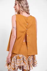 Musculosa de algodón color mostaza, con cuello redondo y diseño clásico holgado, con cierre de botones en la espalda.