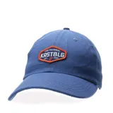 Gorra de gabardina color azul, con parche bordado frontal en forma hexagonal con borde naranja y texto decorativo.