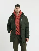 Campera puffer de corte largo, color verde militar, con capucha fija, cierre frontal y puños elásticos internos.