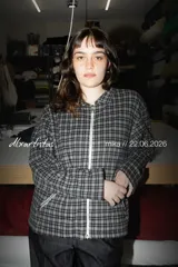 Top de manga larga con cuello alto, confeccionado en tejido de malla semitransparente con estampado gráfico abstracto en tonos verdes y negros.