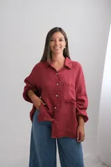 Camisa de lino italiano color bordó, de corte oversize y diseño holgado. Presenta cuello clásico, cierre frontal con botones, bolsillo aplicado en el pecho y mangas largas con puños elásticos.