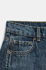 Jeans de tiro medio confeccionados en denim con efecto lavado, diseño de pernera curva y corte recto. Cuenta con cinco bolsillos, trabillas en la cintura y cierre frontal con cremallera y botón metálico.
