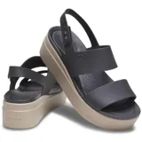 Sandalias tipo plataforma Crocs modelo Brooklyn Low Wedge, con tiras superiores en color azul marino y base de plataforma en color beige. Diseño ergonómico con tira ajustable en el talón.