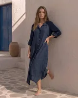 Vestido camisero amplio y largo color azul marino, fabricado en lino, con botones frontales y mangas largas arremangables.