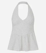 Blusa Blue Steel de bengalina con estampado de lunares, diseño frente única con escote profundo y espalda abierta. Presenta un recorte bajo el busto con efecto peplum que aporta volumen y estructura a la prenda.