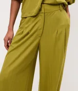 Pantalón balloon de piqué color terracota, con cintura estructurada, pinzas delanteras, pasacintos, piernas amplias y dobladillos elásticos.