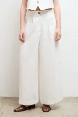Pantalón blanco de lino, de corte palazzo, tiro alto y pierna ancha.