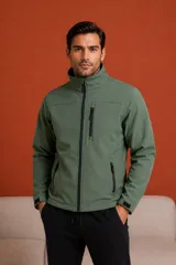 Campera de neopreno color verde militar, con cuello alto, cierre frontal completo y bolsillos con cierre en el pecho y los laterales. Cuenta con ajuste de velcro en los puños.
