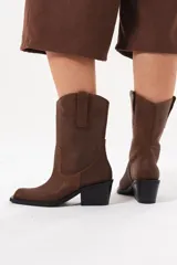 Bota de caña media de cuero marrón con acabado texturado, diseño de estilo western, tiradores laterales y taco medio cuadrado.