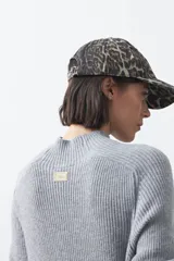 Gorro tipo cap con visera, confeccionado en tela con estampado animal print de leopardo.
