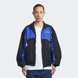 Campera deportiva Adidas Cutline Track Top de corte holgado, con diseño en bloques de color negro y azul, cuello alto y cierre frontal con cremallera. Presenta las icónicas tres tiras de la marca en las mangas y el logotipo bordado en el pecho.