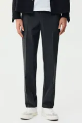 Pantalón tipo jogger de vestir con pliegues frontales y traseros, cintura elástica con cordón de ajuste, bolsillos laterales al bies y bolsillos traseros insertados. Presenta un corte slim fit entallado.