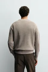 Sweater de punto perlado en color gris, con diseño relaxed fit, cuello redondo y manga larga. Cuenta con acabados en rib en cuello, puños y dobladillo.