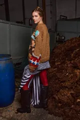 Sweater marrón de lana tejido a mano con cuello redondo y puños acanalados. Presenta apliques bordados de figuras infantiles.