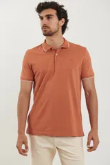 Chomba color ladrillo con cuello polo y mangas cortas con ribete blanco.