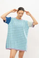 Vestido tipo remerón tejido en algodón con diseño a cuadros en tonos celeste, azul y lila.