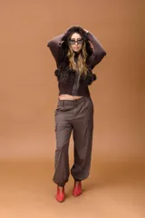 Pantalón cargo de tiro medio en color marrón, con diseño de silueta relajada, bolsillos laterales tipo cargo y puños elásticos en los tobillos.