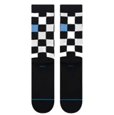 Medias de caña media Stance con diseño de tablero de ajedrez en color negro y blanco, con detalles en azul claro. Presentan el logo de la marca bordado en el lateral.