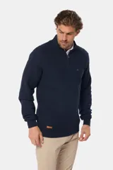 Buzo azul marino de algodón texturizado, con cuello alto y medio cierre con cremallera. Presenta un pequeño logo bordado en el pecho.