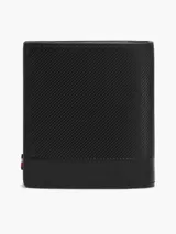 Billetera trifold de cuero vacuno color negro con textura acanalada y logo de Tommy Hilfiger en la parte inferior. Cuenta con múltiples ranuras para tarjetas, compartimento para billetes y bolsillo interior con cierre a presión para monedas.