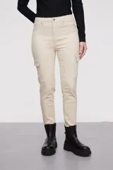 Pantalon tipo cargo de jean en color natural, con bolsillos laterales con solapa y cierre frontal con botón y cremallera.