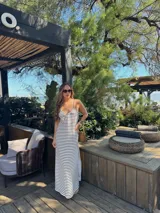 Vestido largo de jersey, color negro con rayas horizontales blancas, corte recto y tirantes finos.