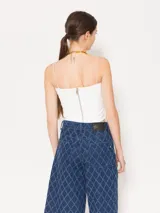 Top blanco de breteles finos, corte ajustado y largo hasta la cintura.