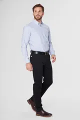 Pantalón de gabardina azul marino de corte slim fit y tiro medio, con bolsillos traseros ojalados con botón y presillas para cinturón.